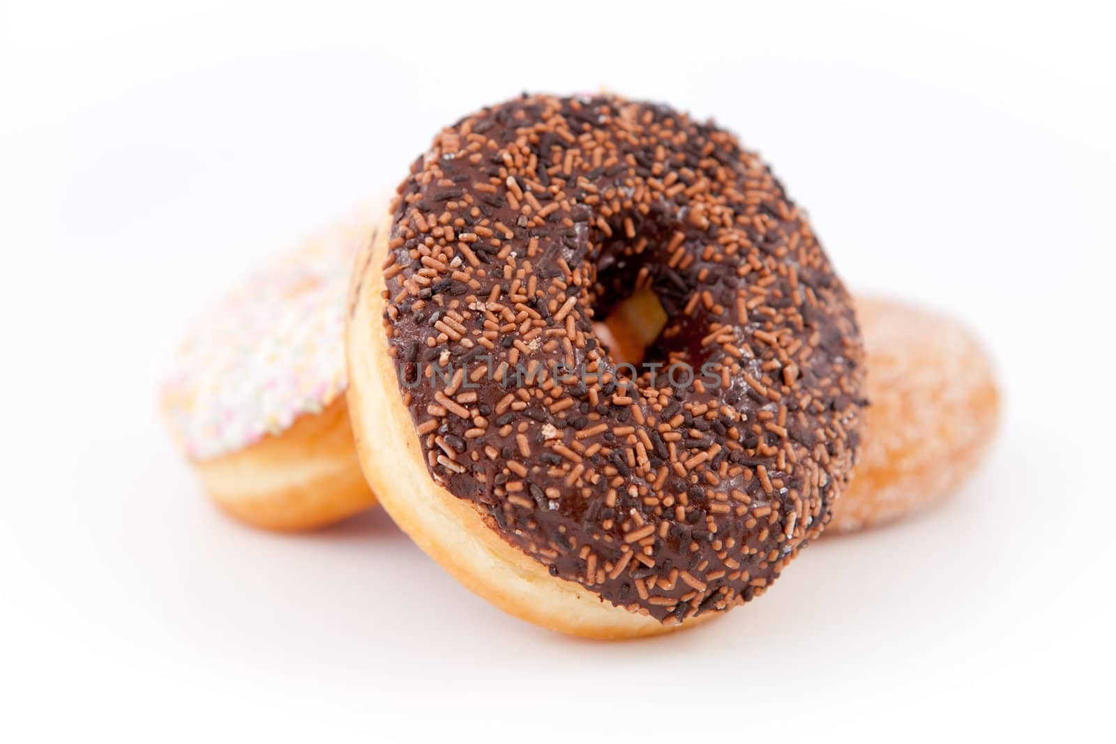 Doughnuts piled up together against a white background