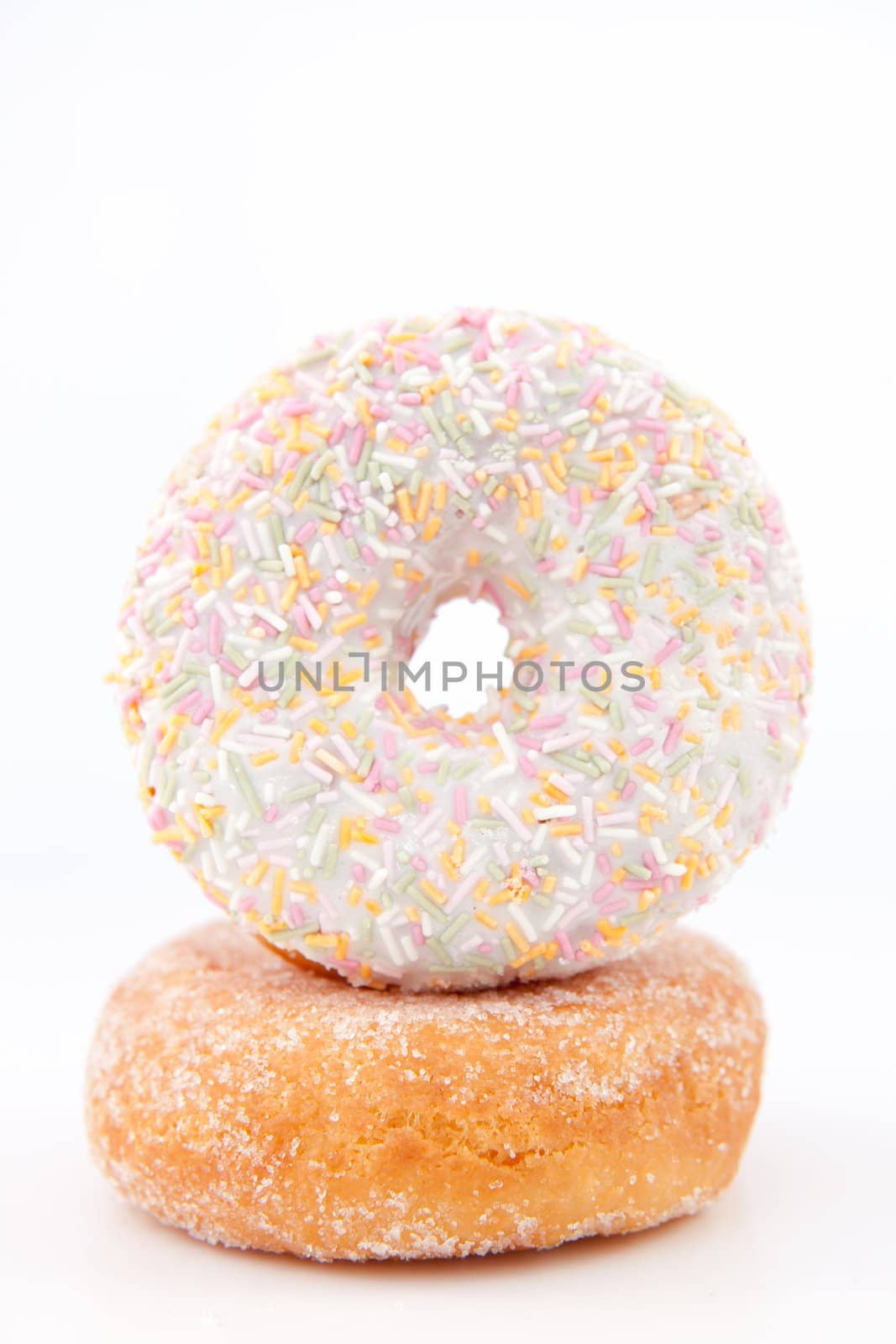 Doughnut with multi coloured icing sugar against a white back ground