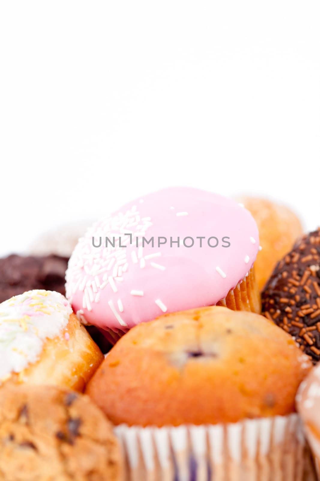 Close up of cakes with icing sugar against a white background