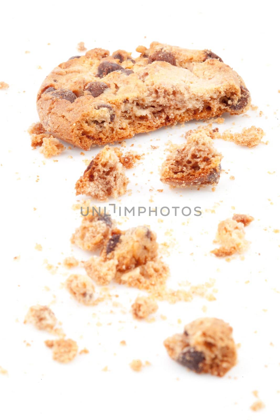 Close up of an half eaten cookie against a white background