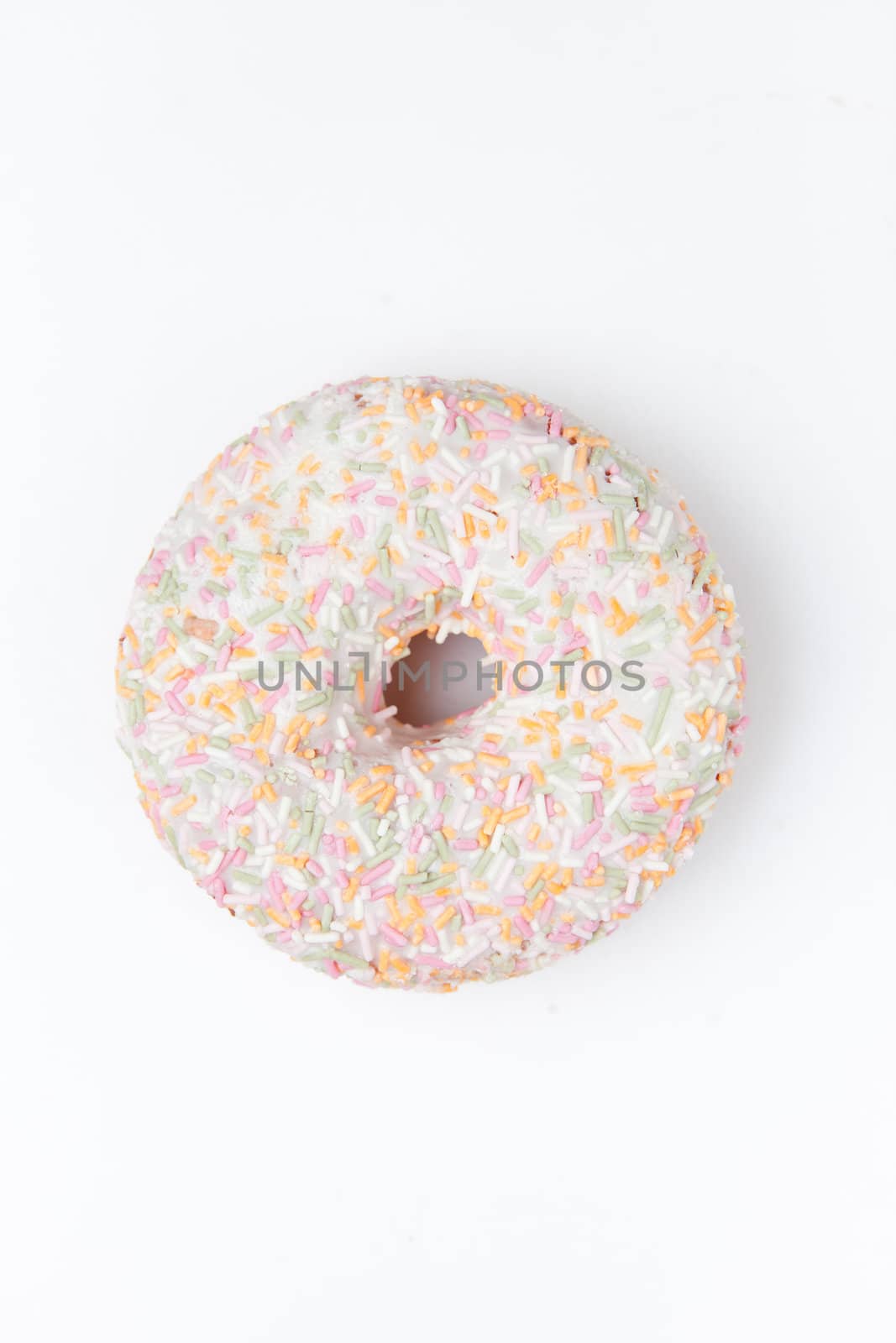 Extreme close up of a doughnut with multi coloured icing sugar by Wavebreakmedia