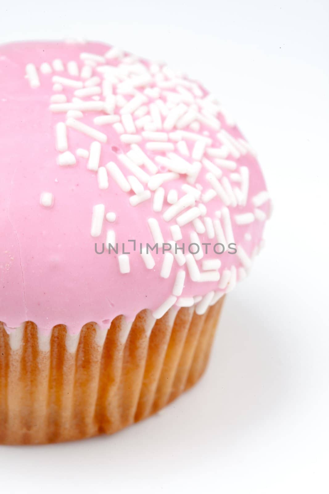 Extreme close up of muffin with icing sugar against a background