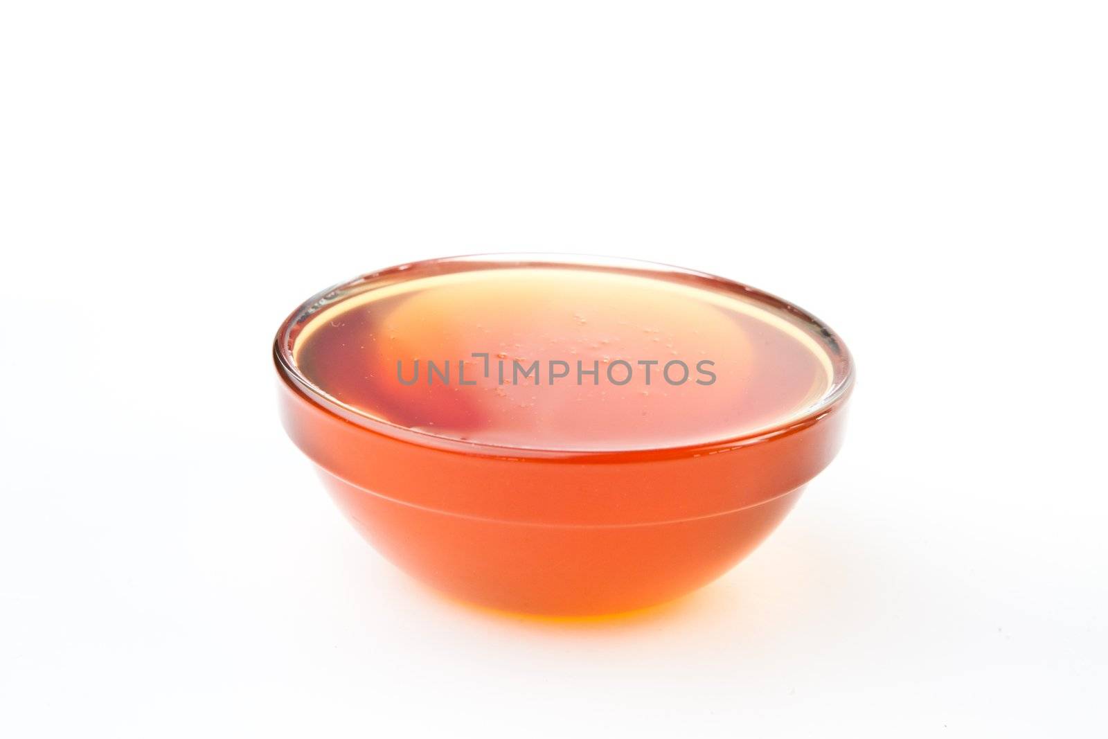 Honey bowl against a white background