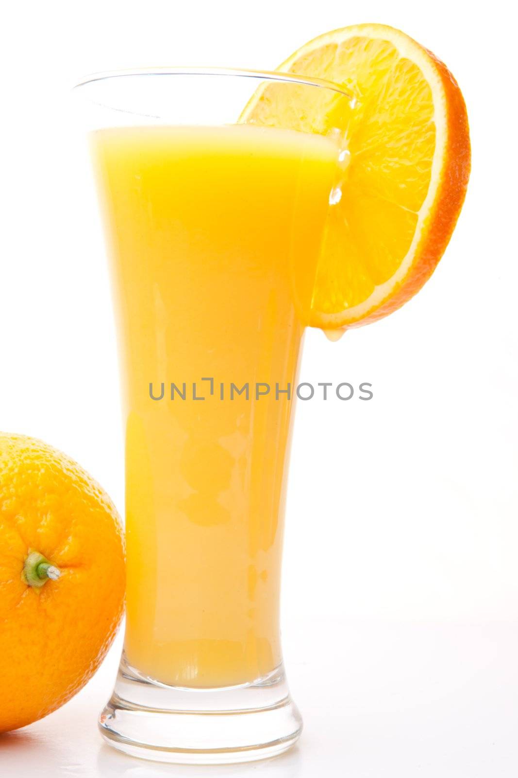 Glass of orange juice near a orange by Wavebreakmedia