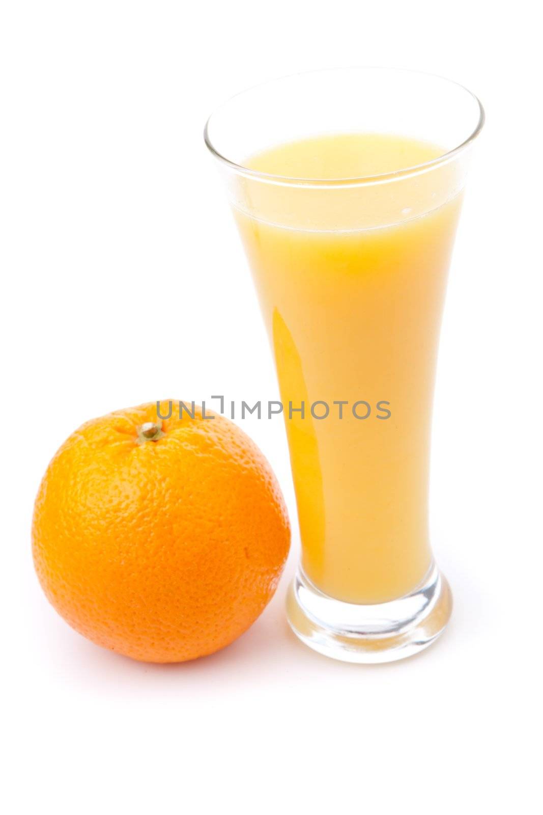 Glass full of orange juice placed near an orange by Wavebreakmedia