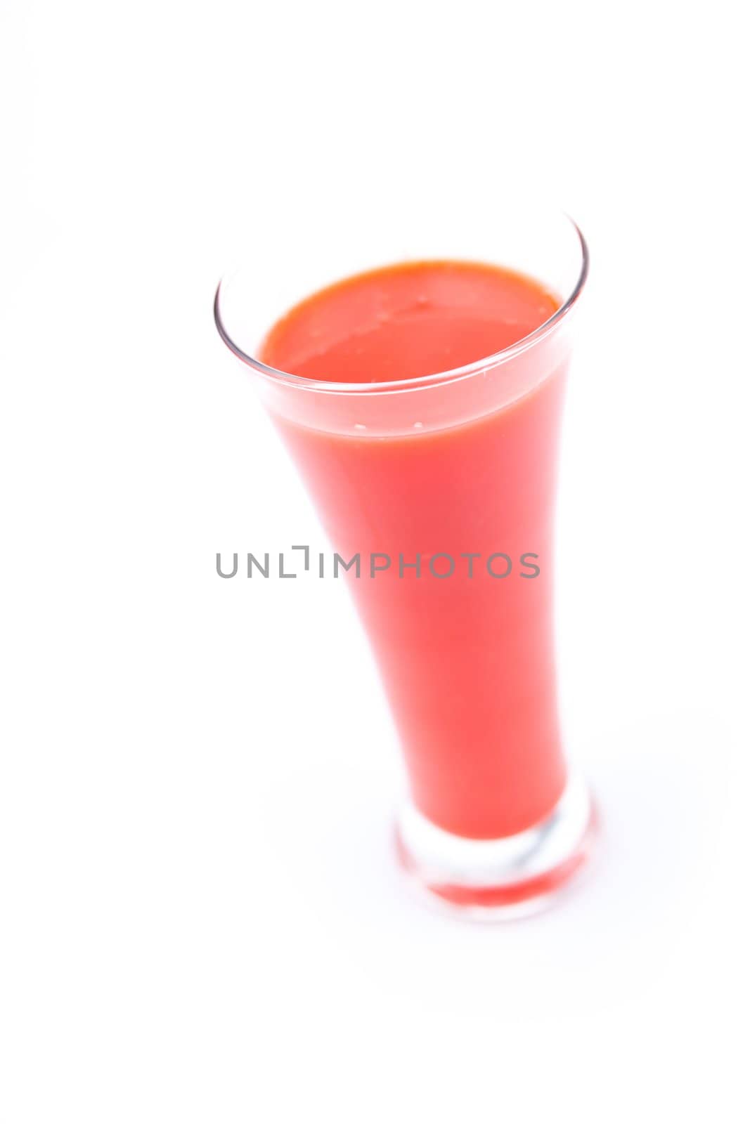 full glass of berries juice against white background