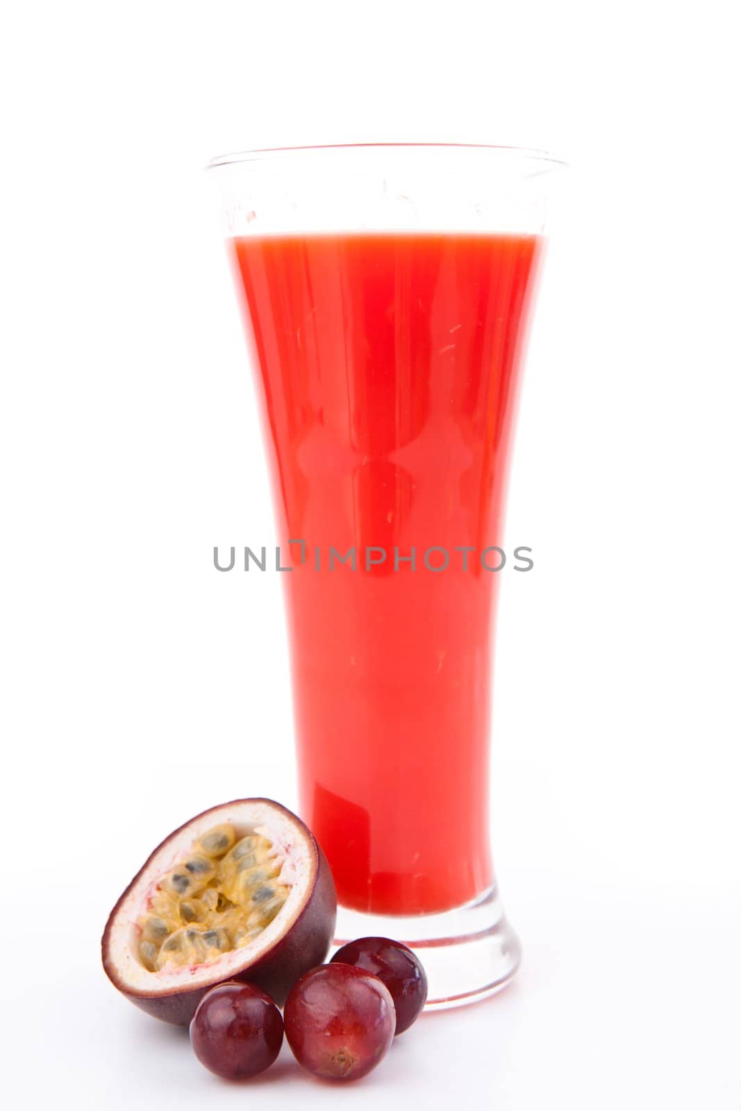 Berries in front of a full glass behind white background