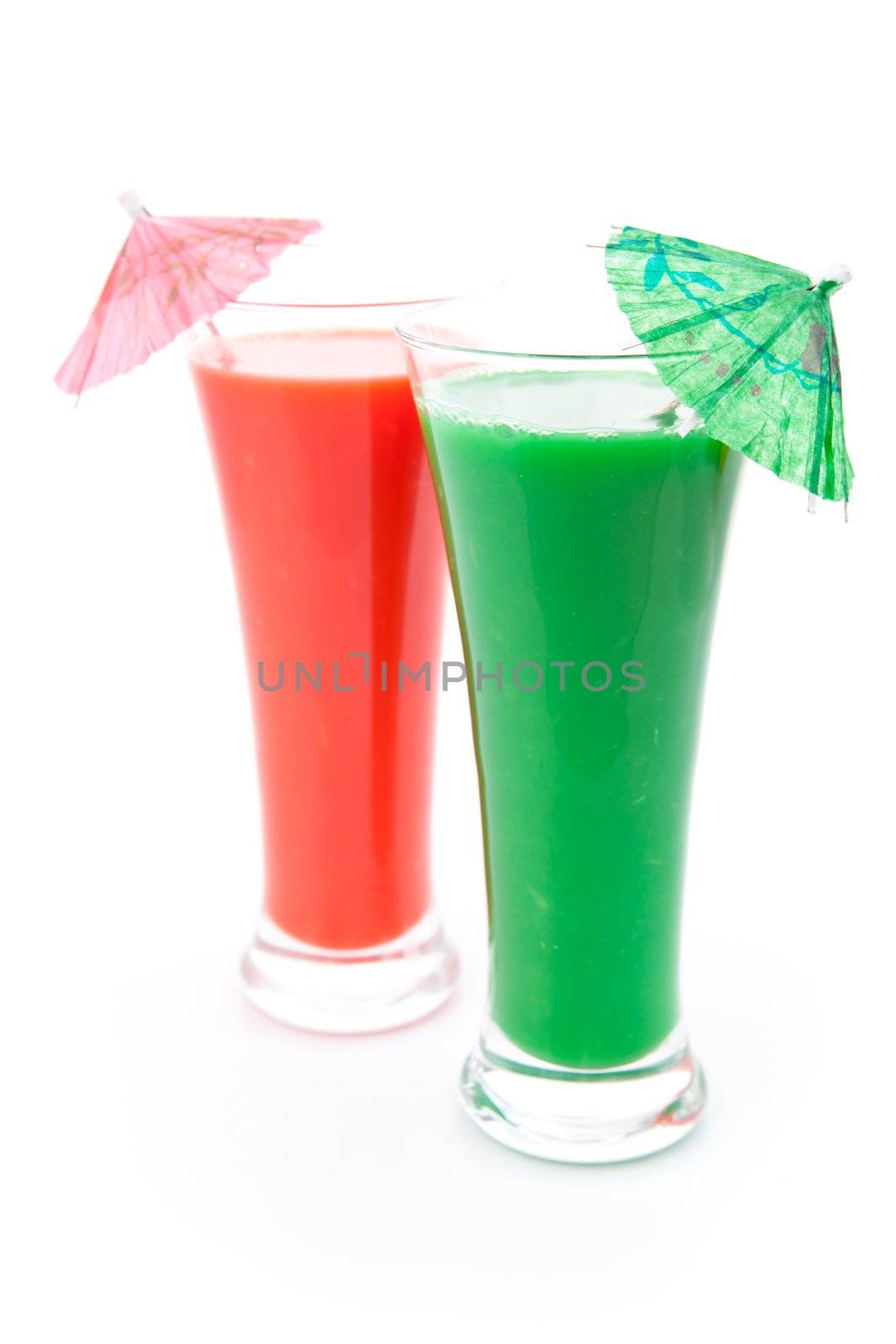 Two full glasses with cocktail umbrella against white background