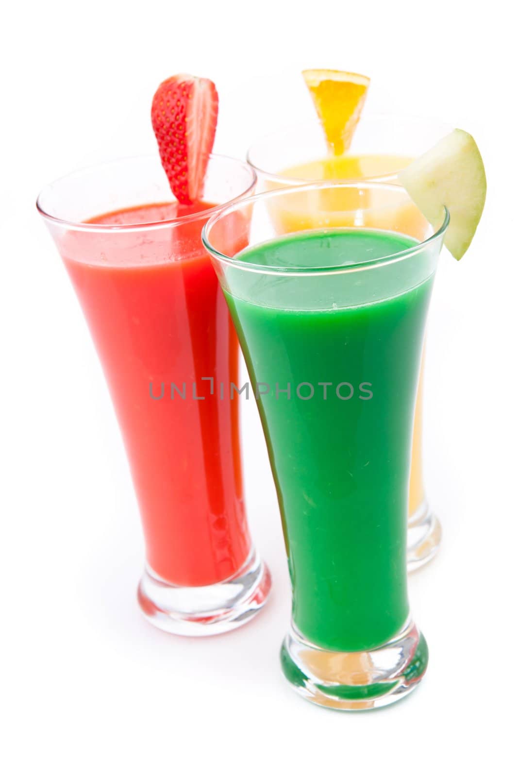 Fruit pieces full glasses against white background