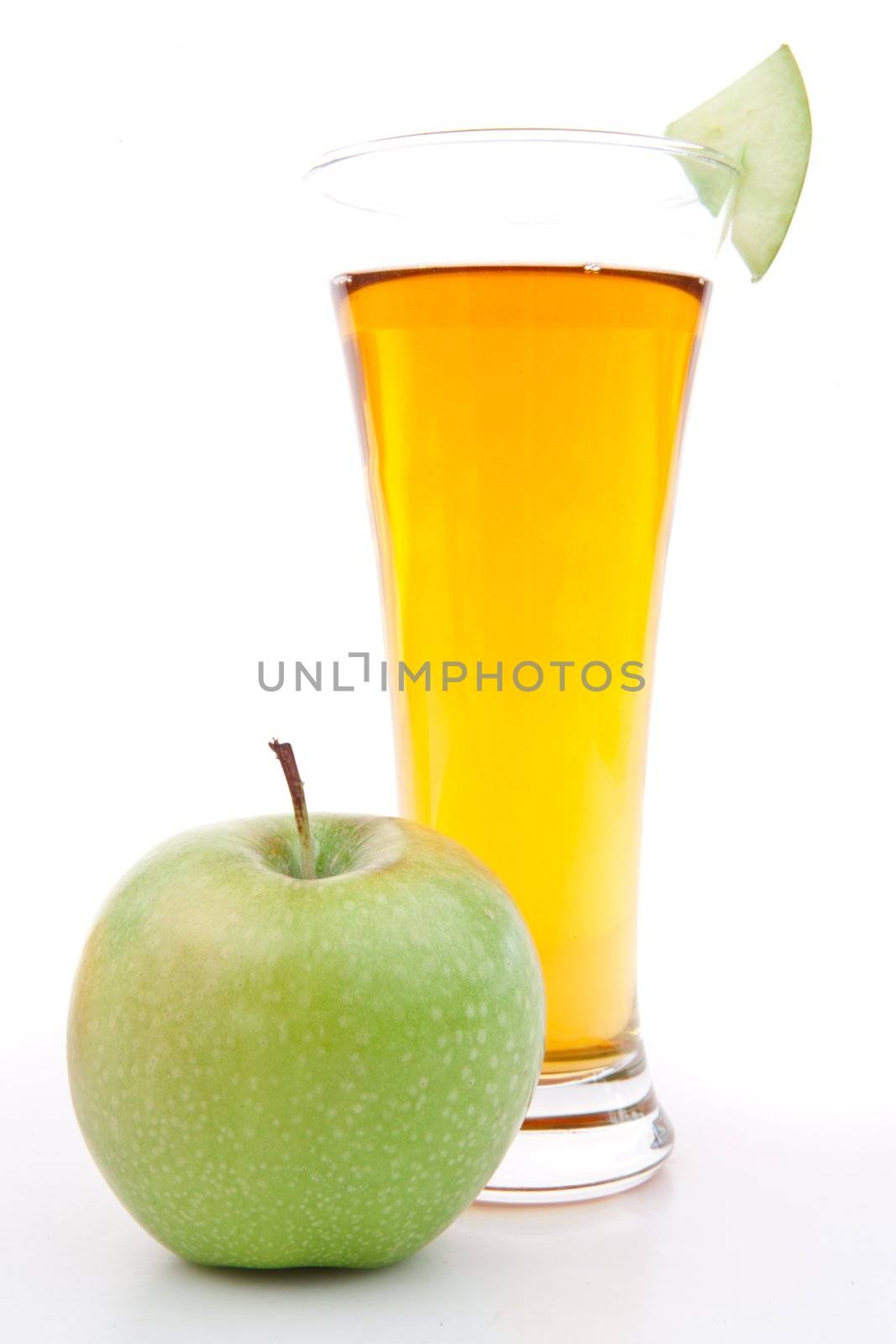 Apple near a glass of apple juice against white background