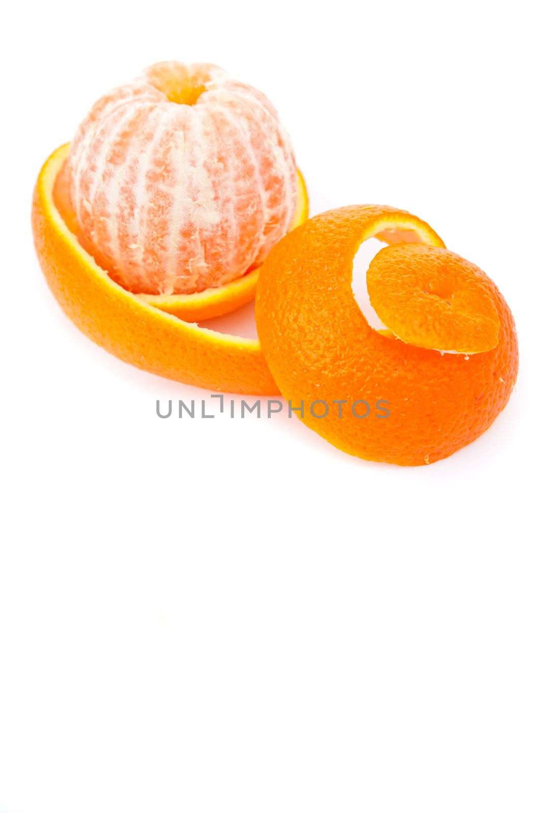 Orange surrounded by an orange peel against white background