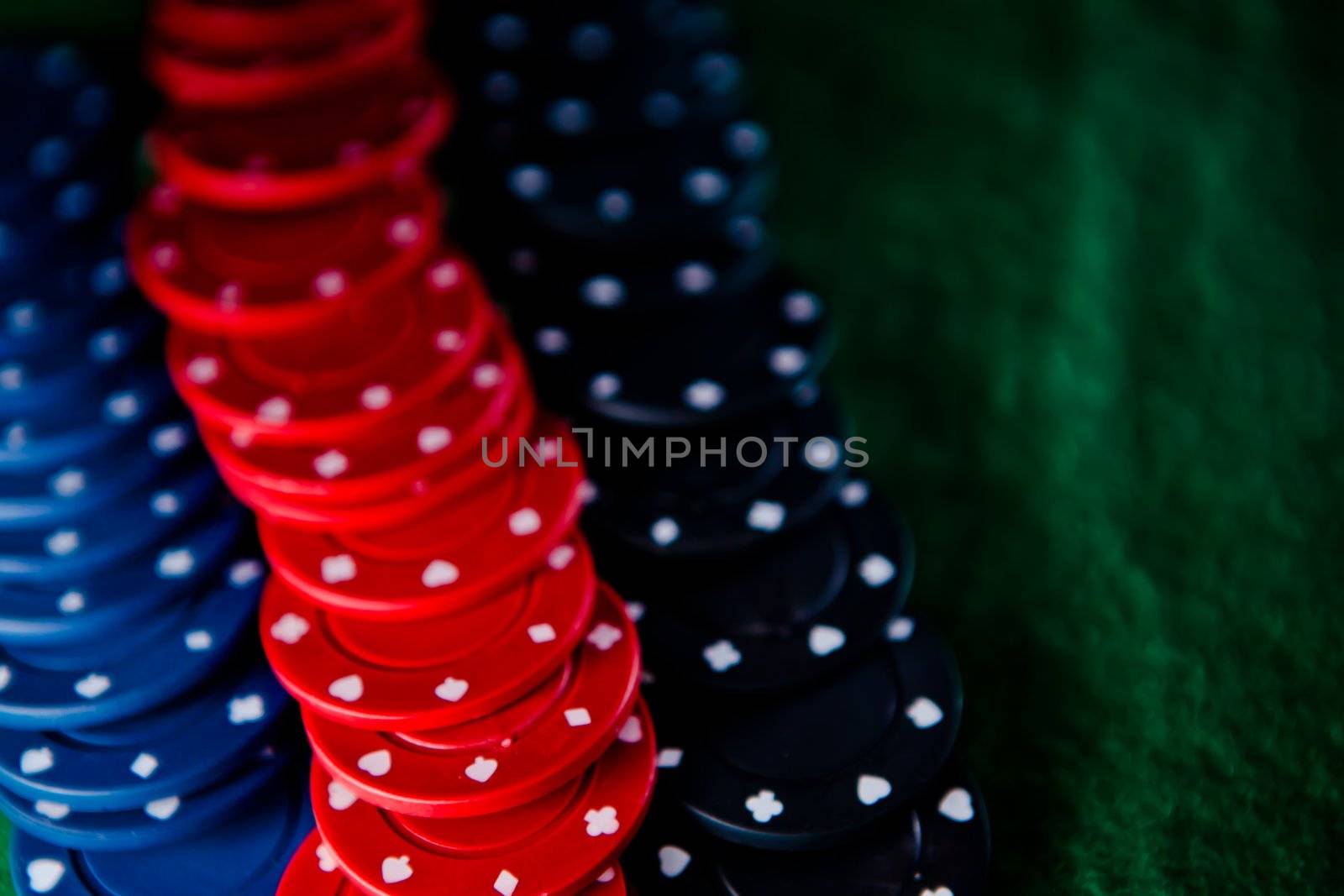 Heap of poker chips on the green mat