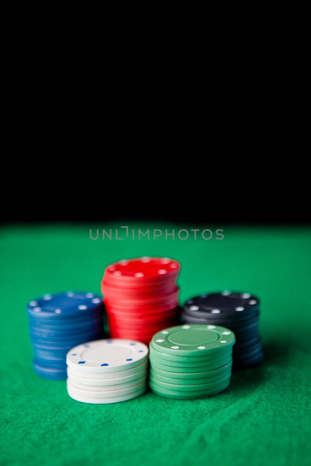 Gambling chips  against a black background