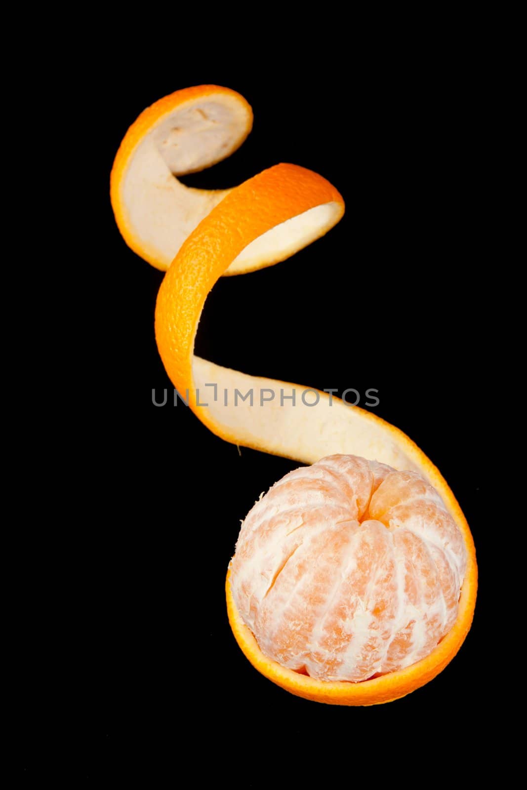 Mandarin with peel against a black background