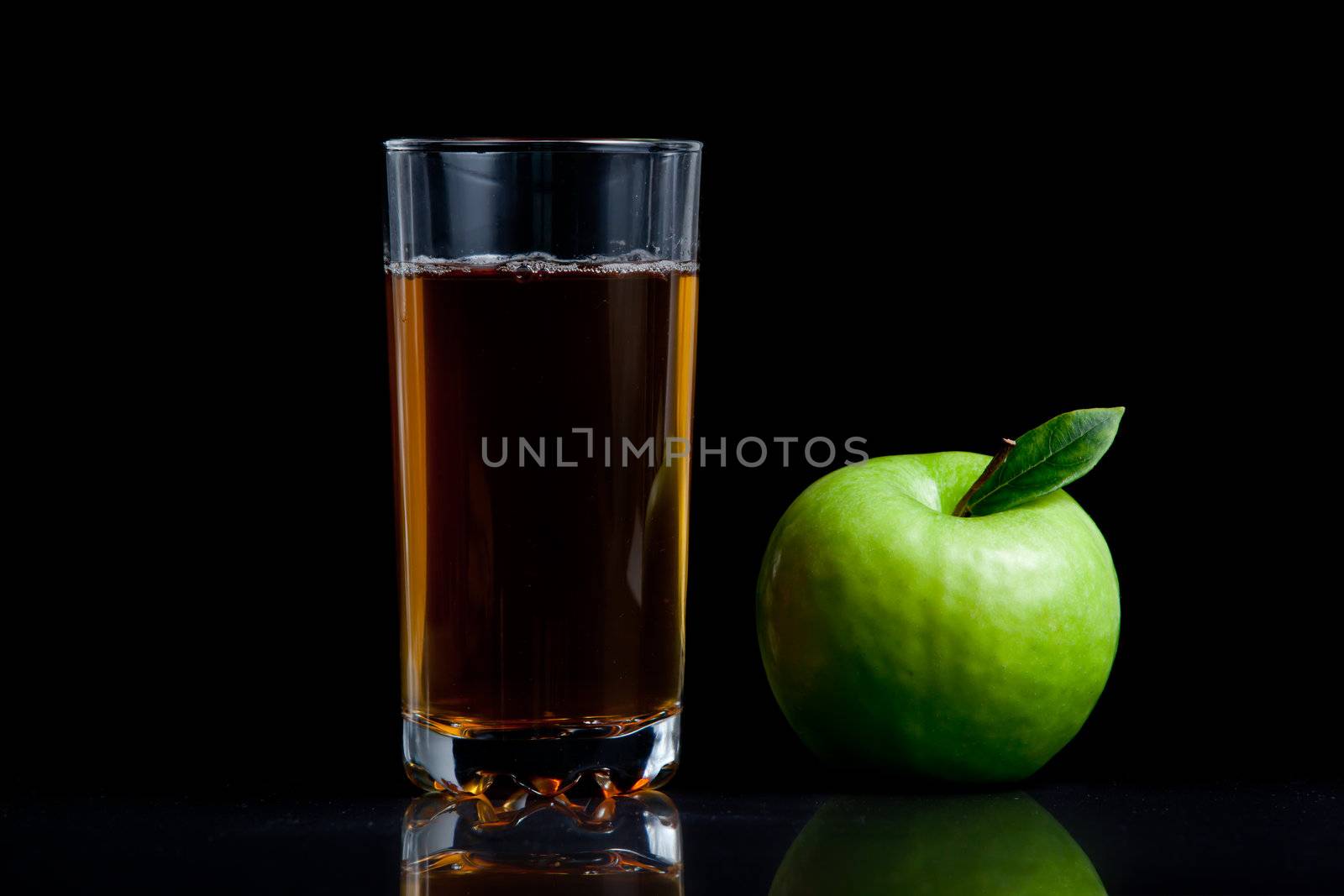 Fresh apple juice against a black background