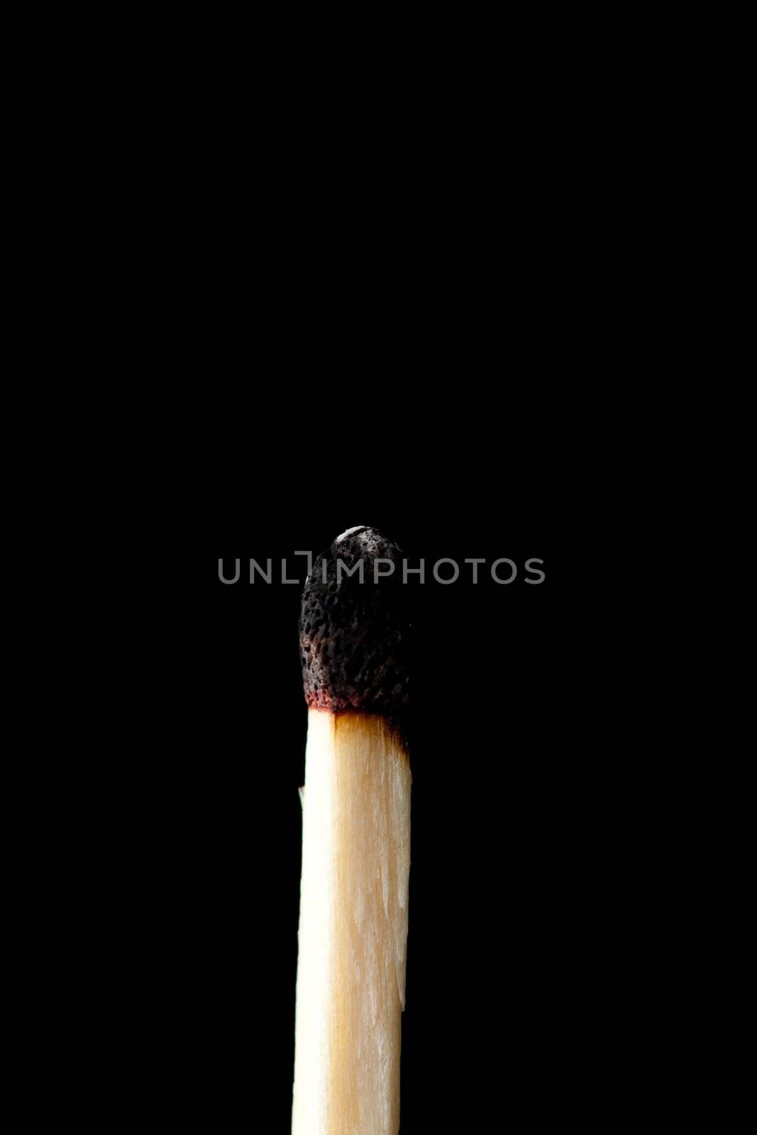 Consumed match against a black background