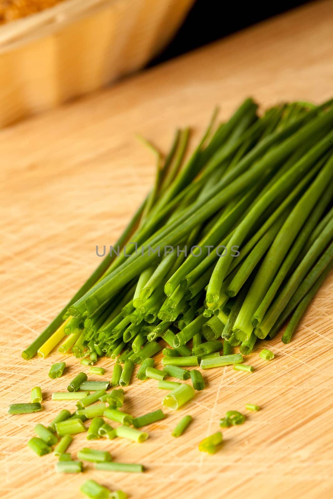 Freshly cut stands of chive on a wooden table