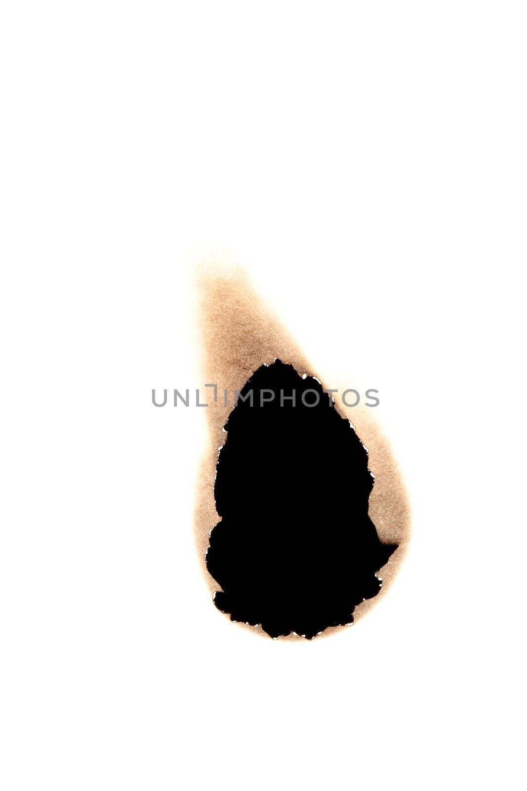 Small burned hole in paper against a white background