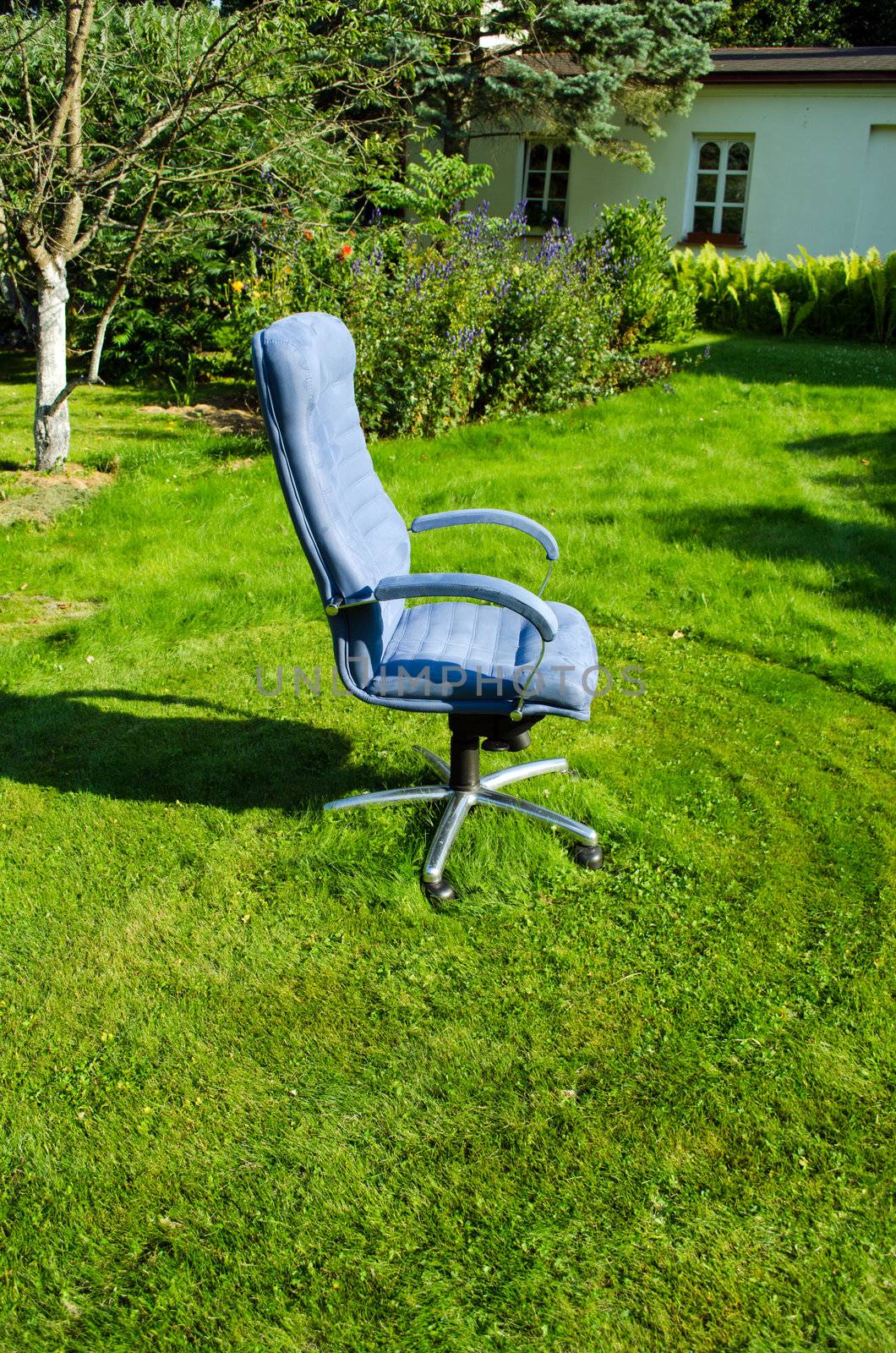 Boss chief office chair in garden and lawn grass cut arround it.