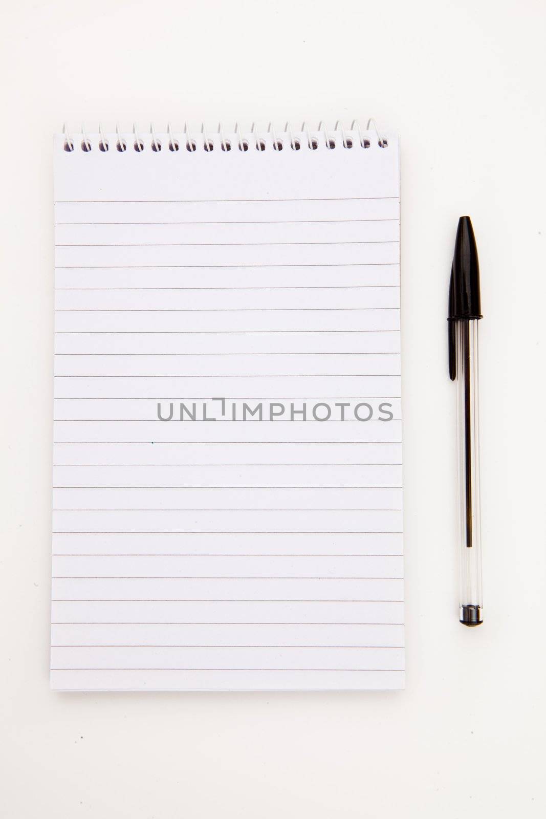 Notepad  with black pen sheet  against a white background