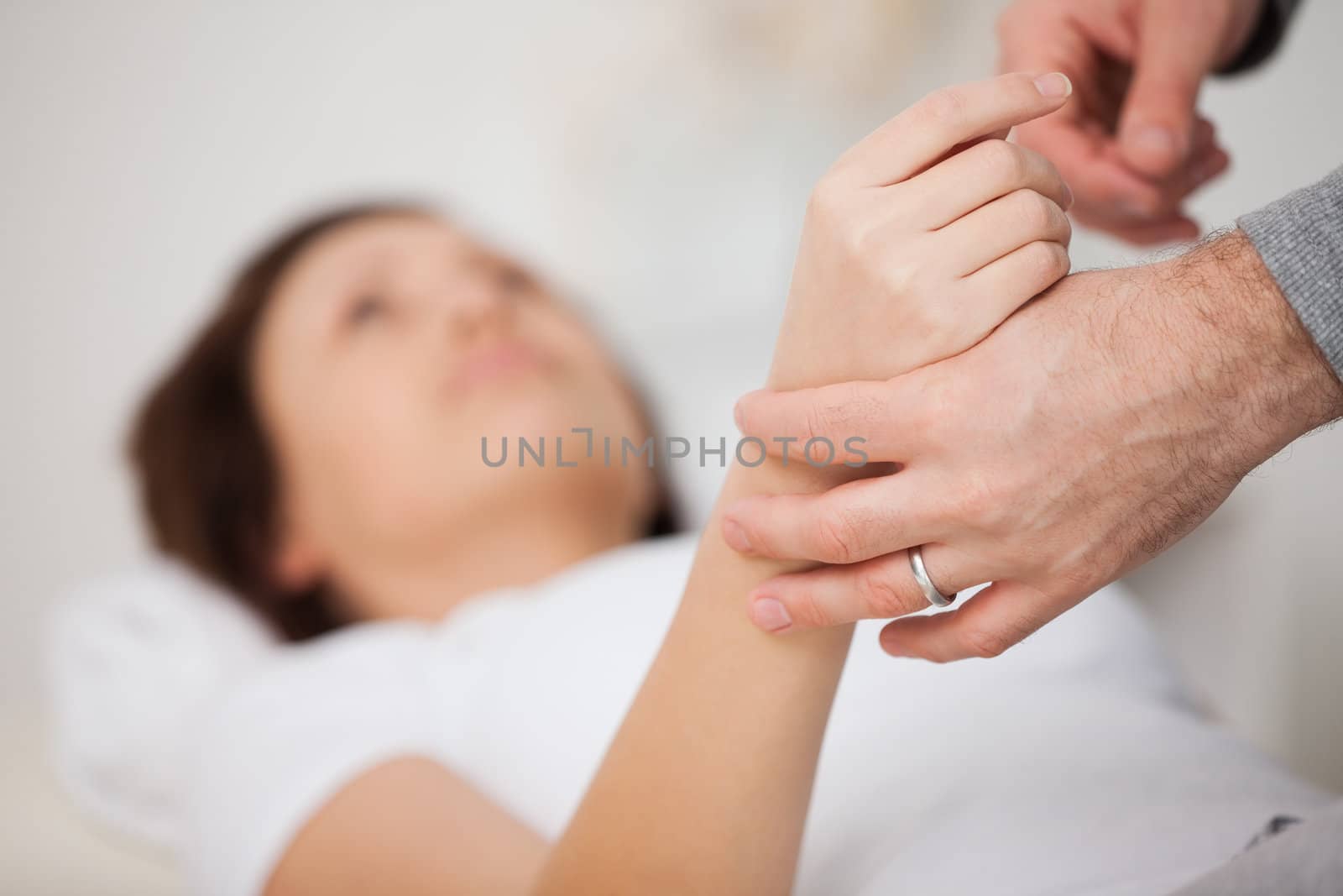 Hand of a woman being manipulated in a medical office
