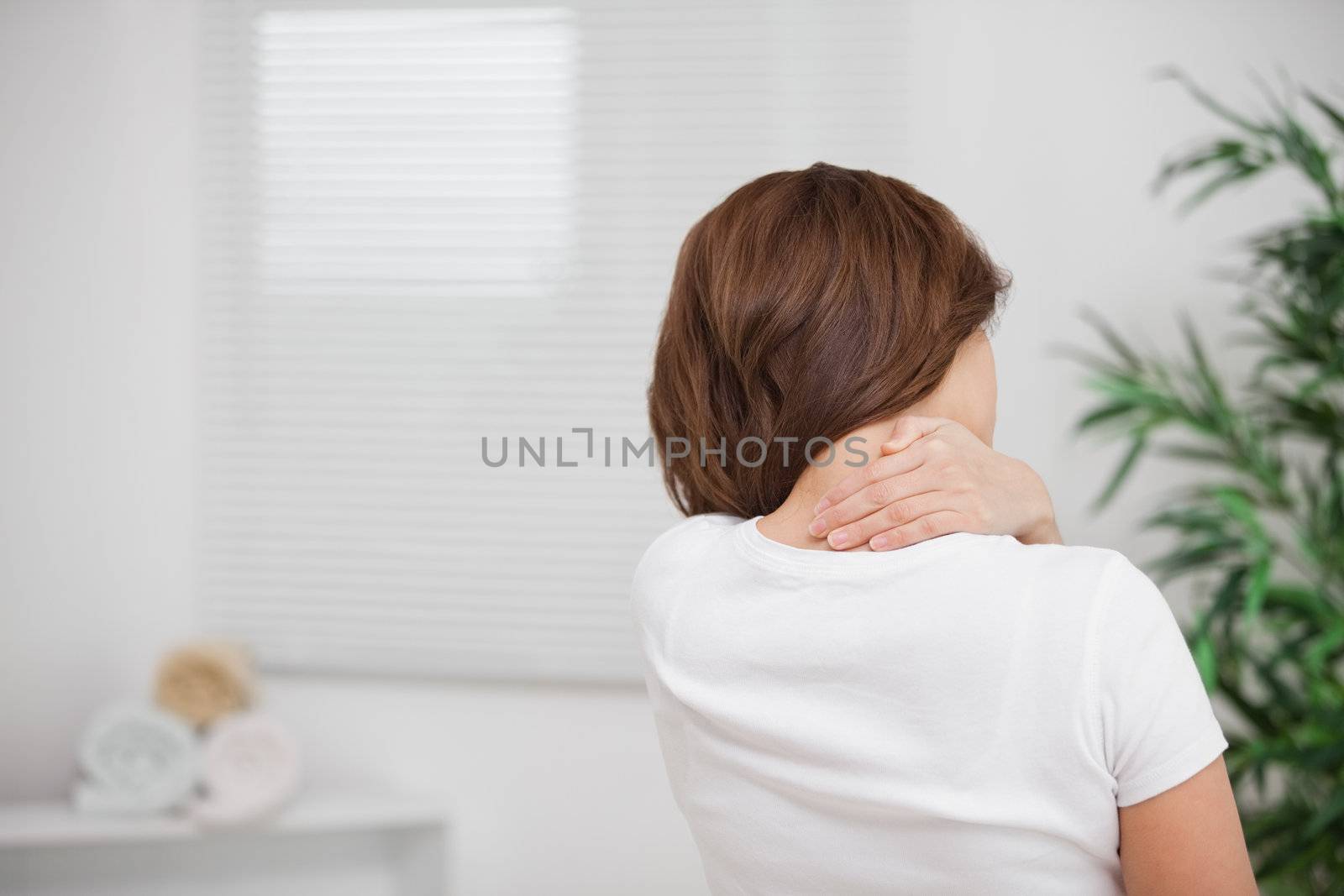 Woman massaging her painful nape by Wavebreakmedia