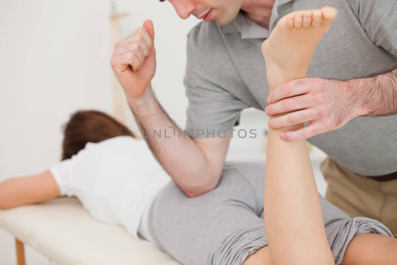 Woman lying while being massaged by her doctor by Wavebreakmedia