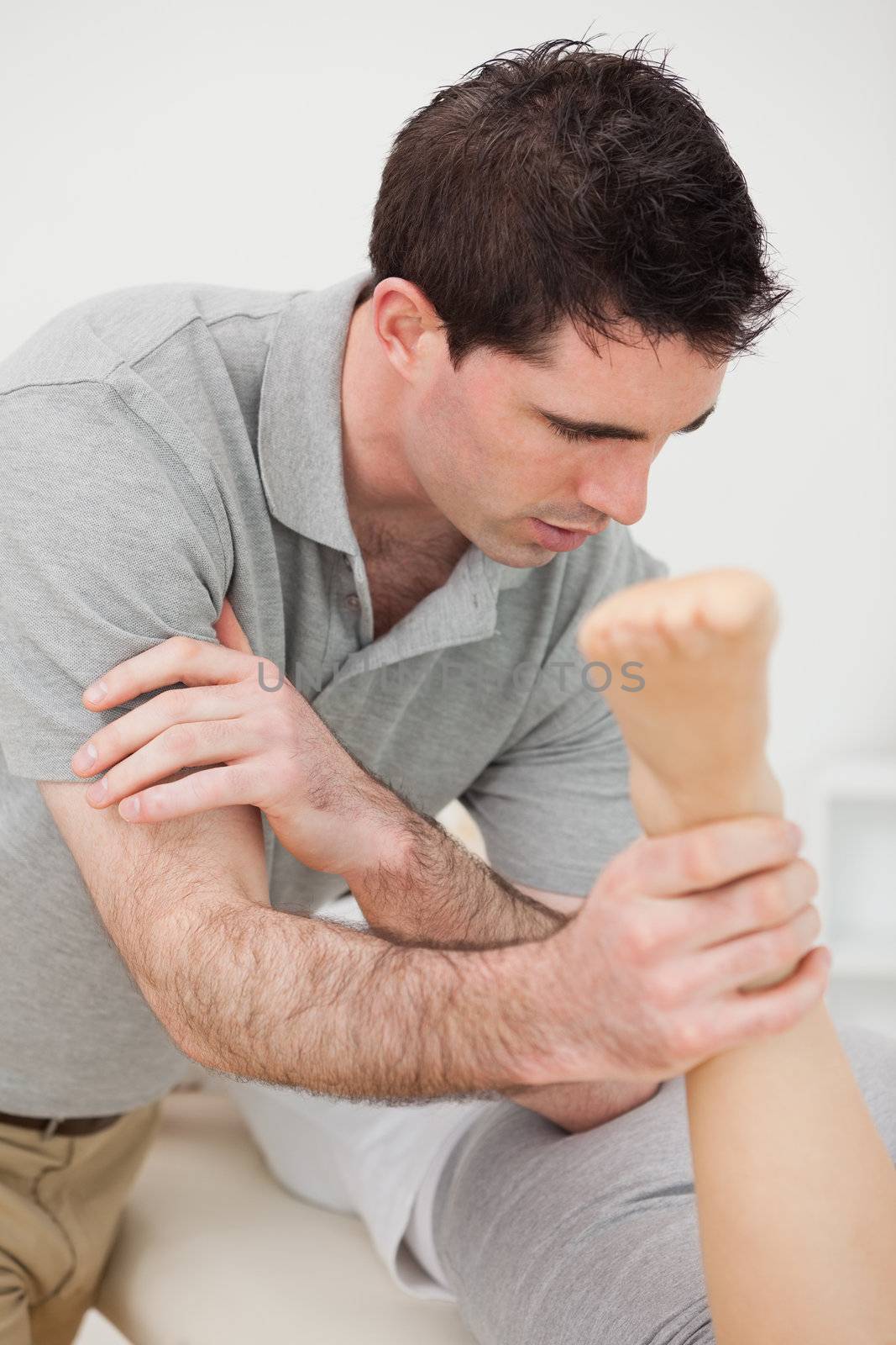 Doctor massaging a patient with his elbow in a room