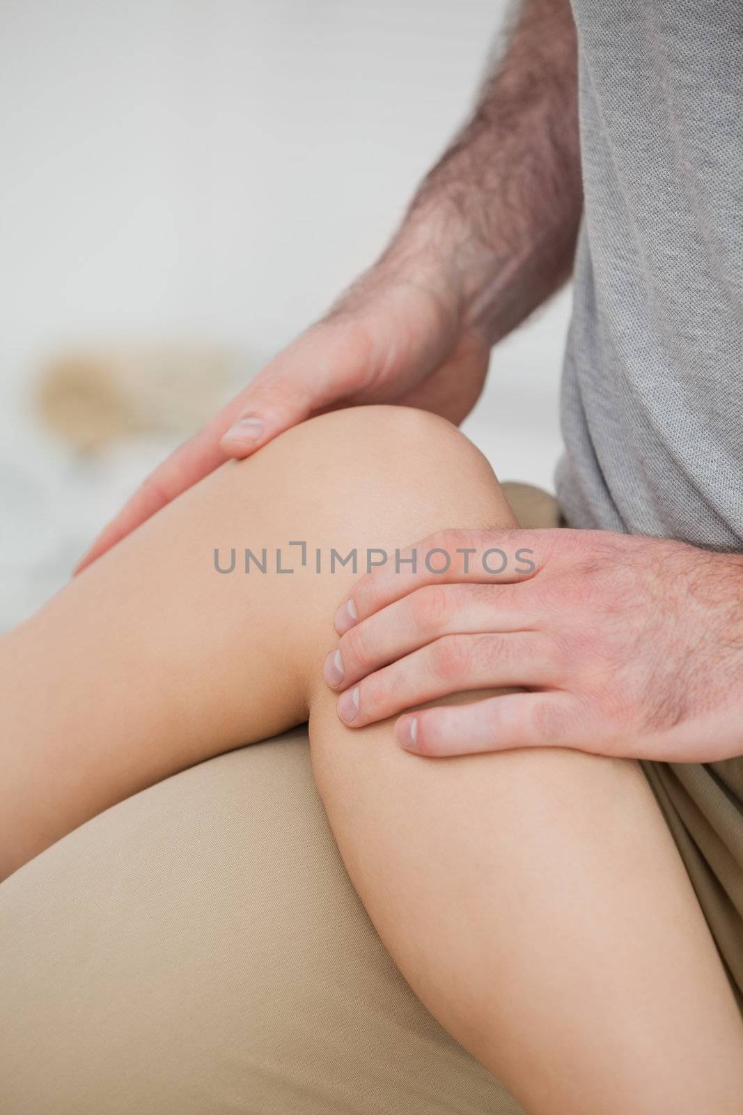 Physiotherapist folding a leg over her thigh in a physio room