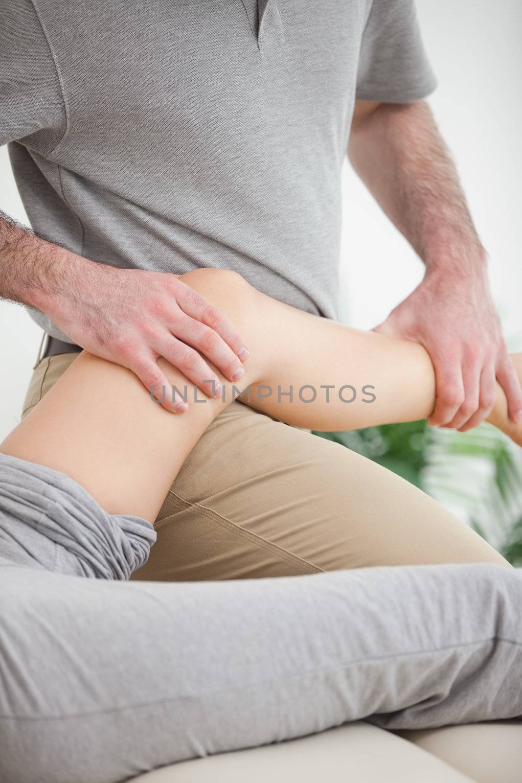 Leg of a patient being placed on the doctor in a room