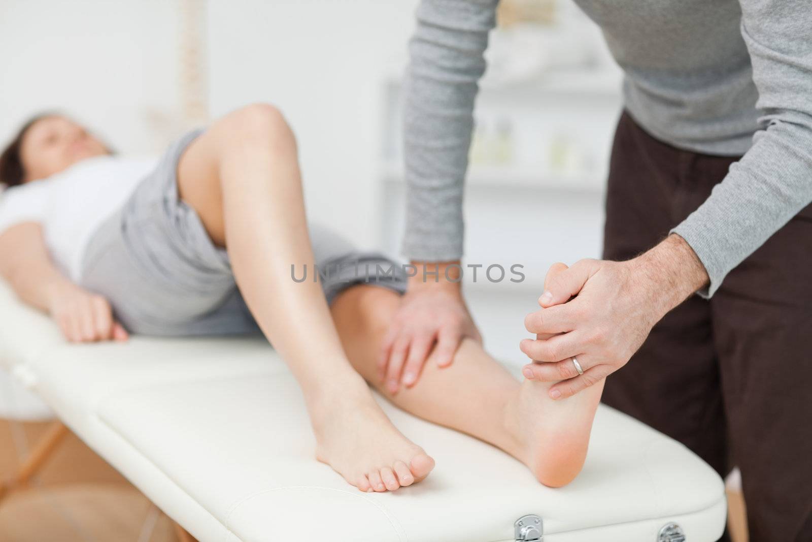 Physiotherapist stretching a barefoot by Wavebreakmedia