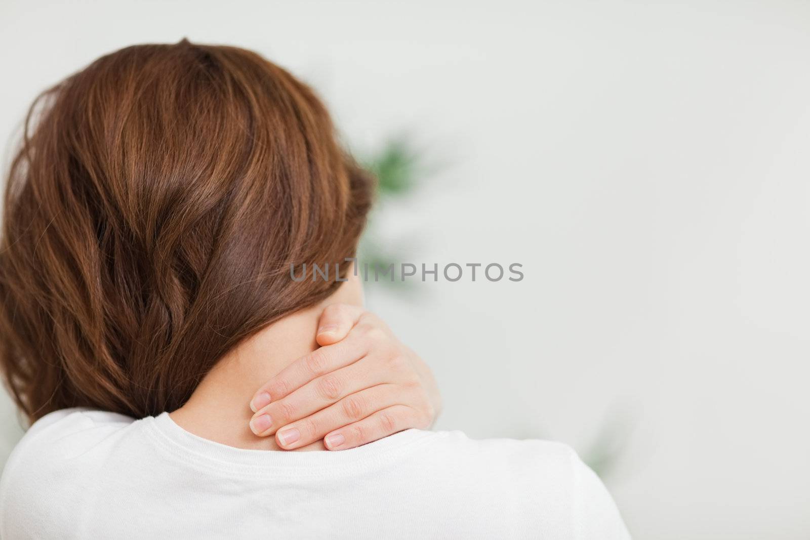 Close up of a brunette woman massing her neck by Wavebreakmedia