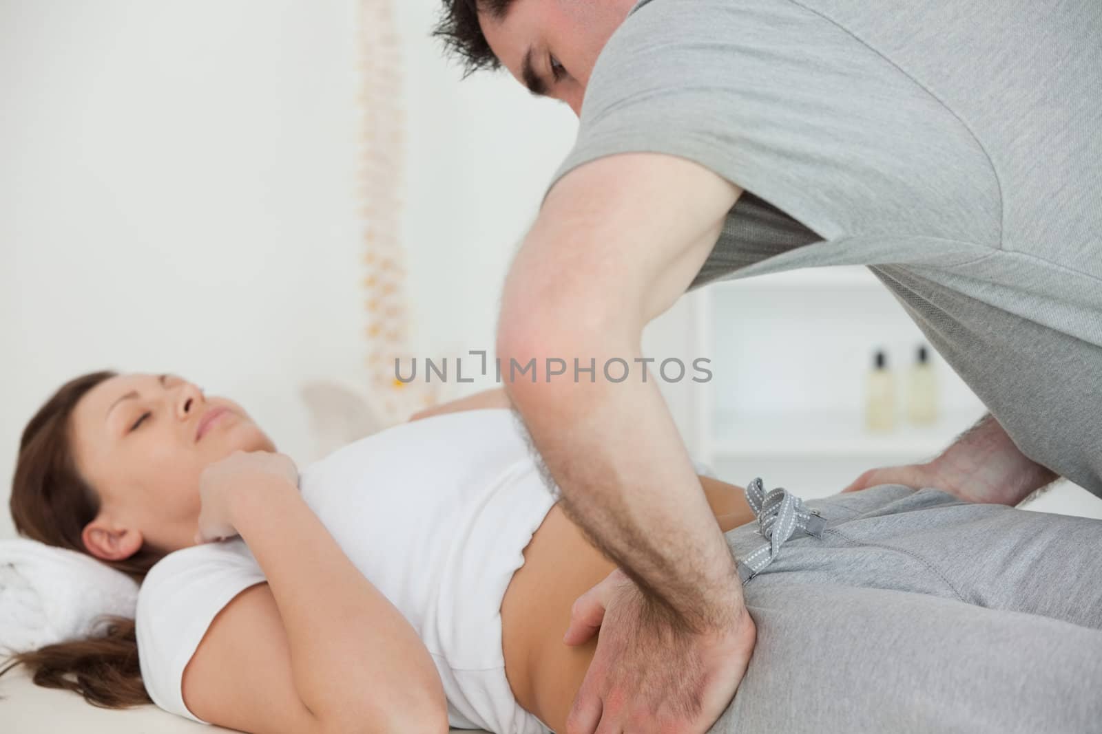 Woman lying while being examined in a room