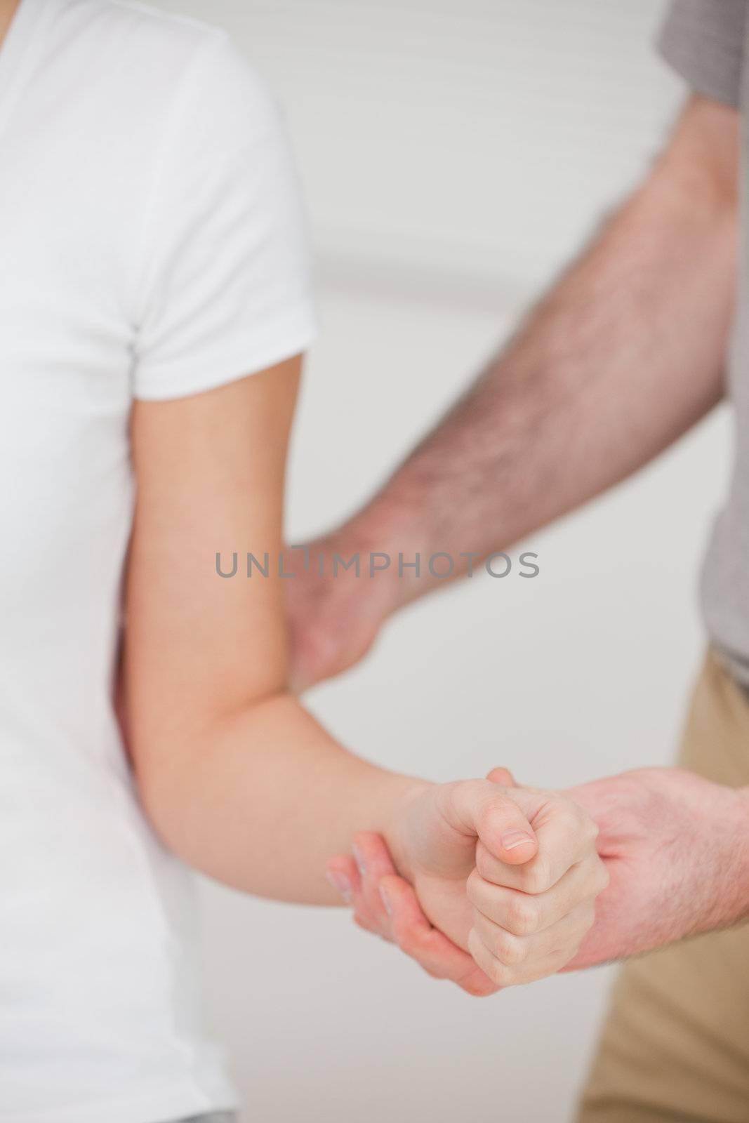 Close up of a a man stretching an elbow by Wavebreakmedia