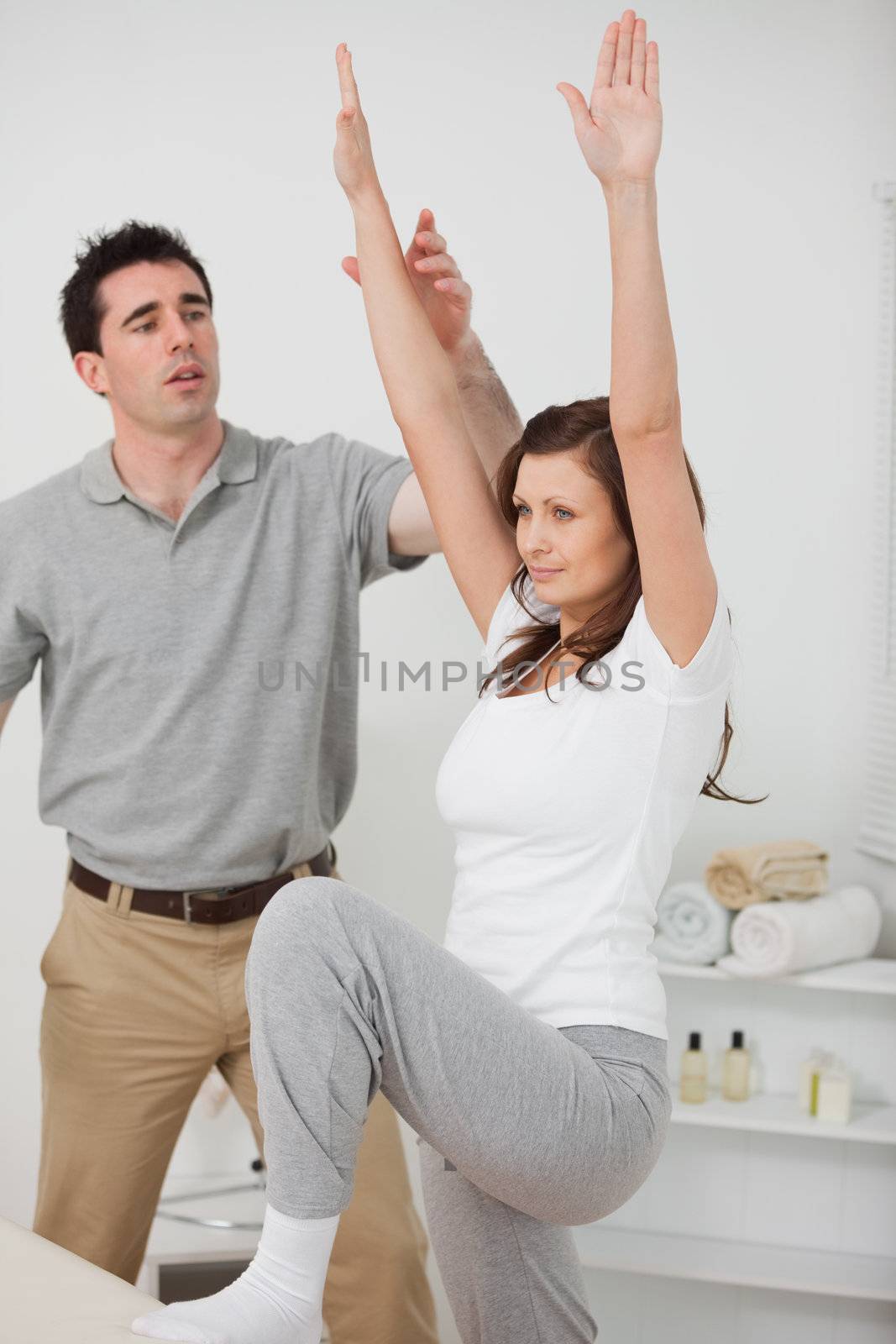 Woman standing while doing her exercises in a room