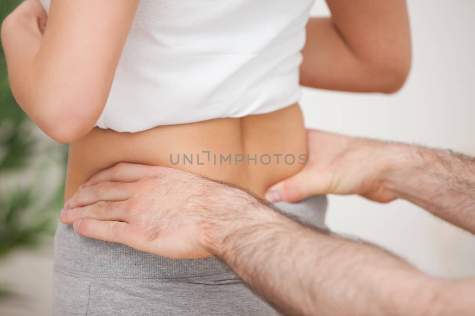 Close-up of a man touching the hips of a woman in a room