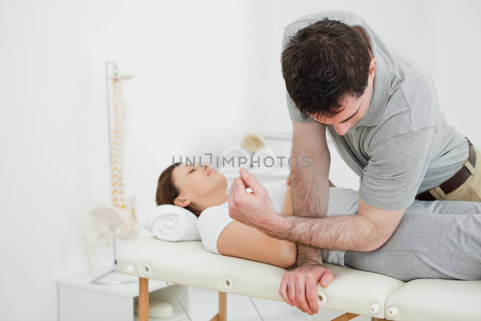 Physiotherapist massaging the pelvis of a woman by Wavebreakmedia
