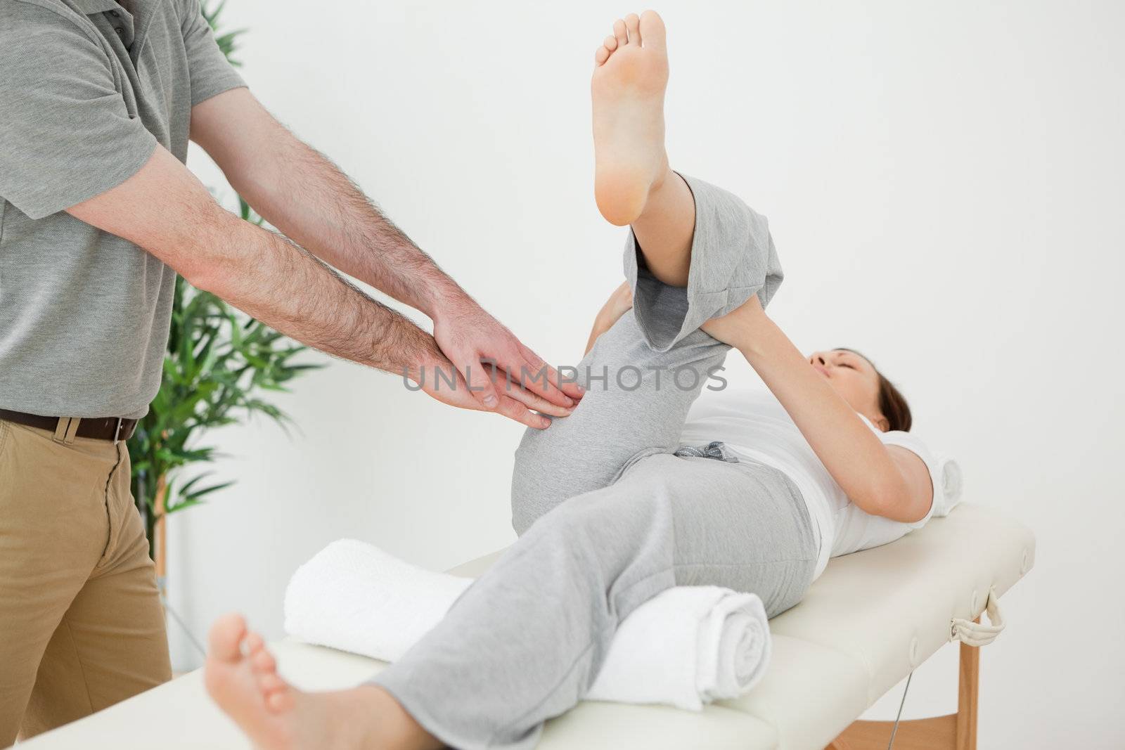Woman stretching her leg while a man is massaging her by Wavebreakmedia