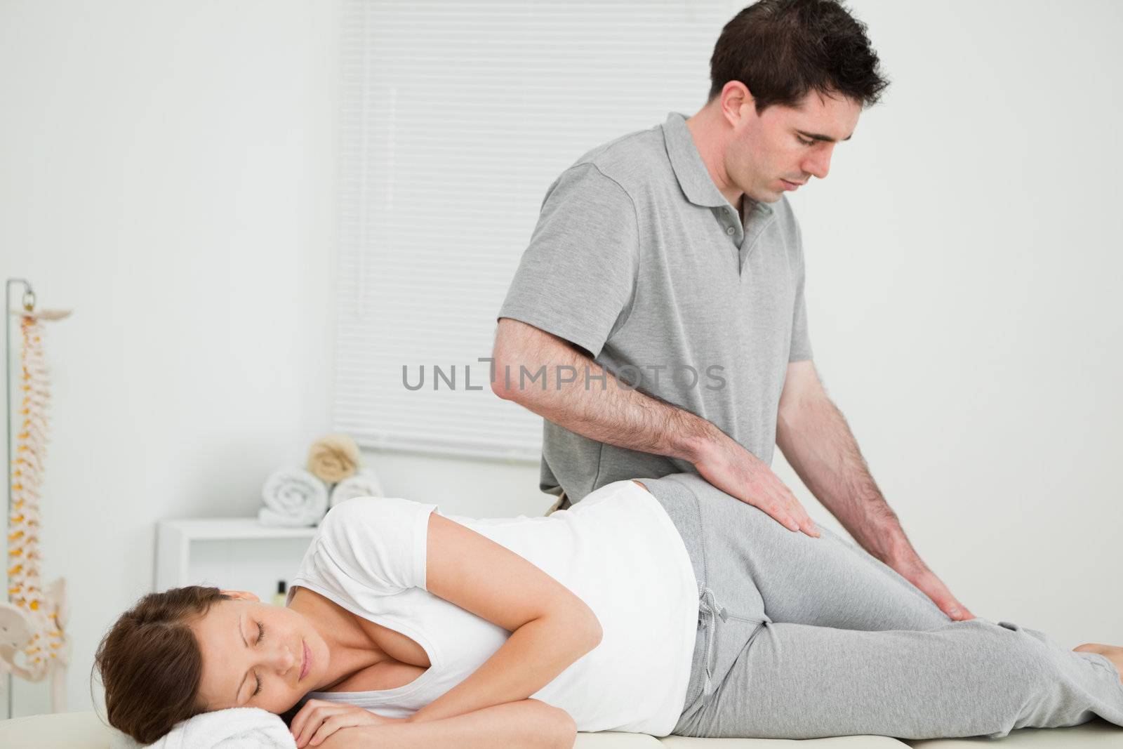 Doctor looking at the thigh of his patient in his office