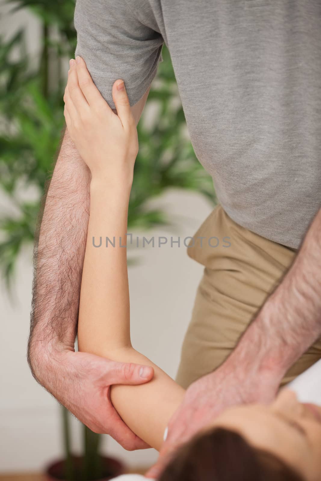Brunette woman being manipulated by a doctor by Wavebreakmedia