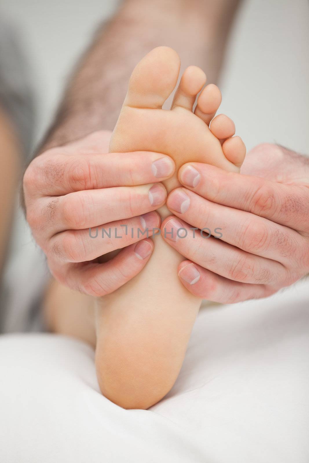 Fingers palpating the sole of a foot by Wavebreakmedia