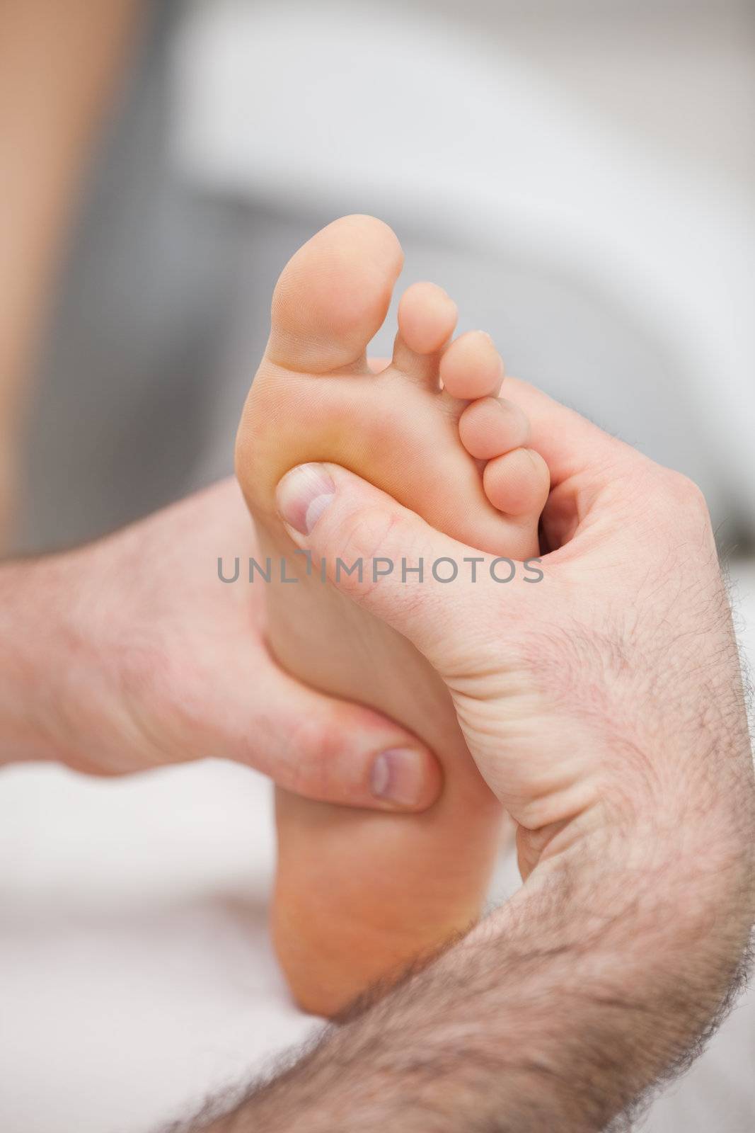 Sole of foot being massaged in a medical room