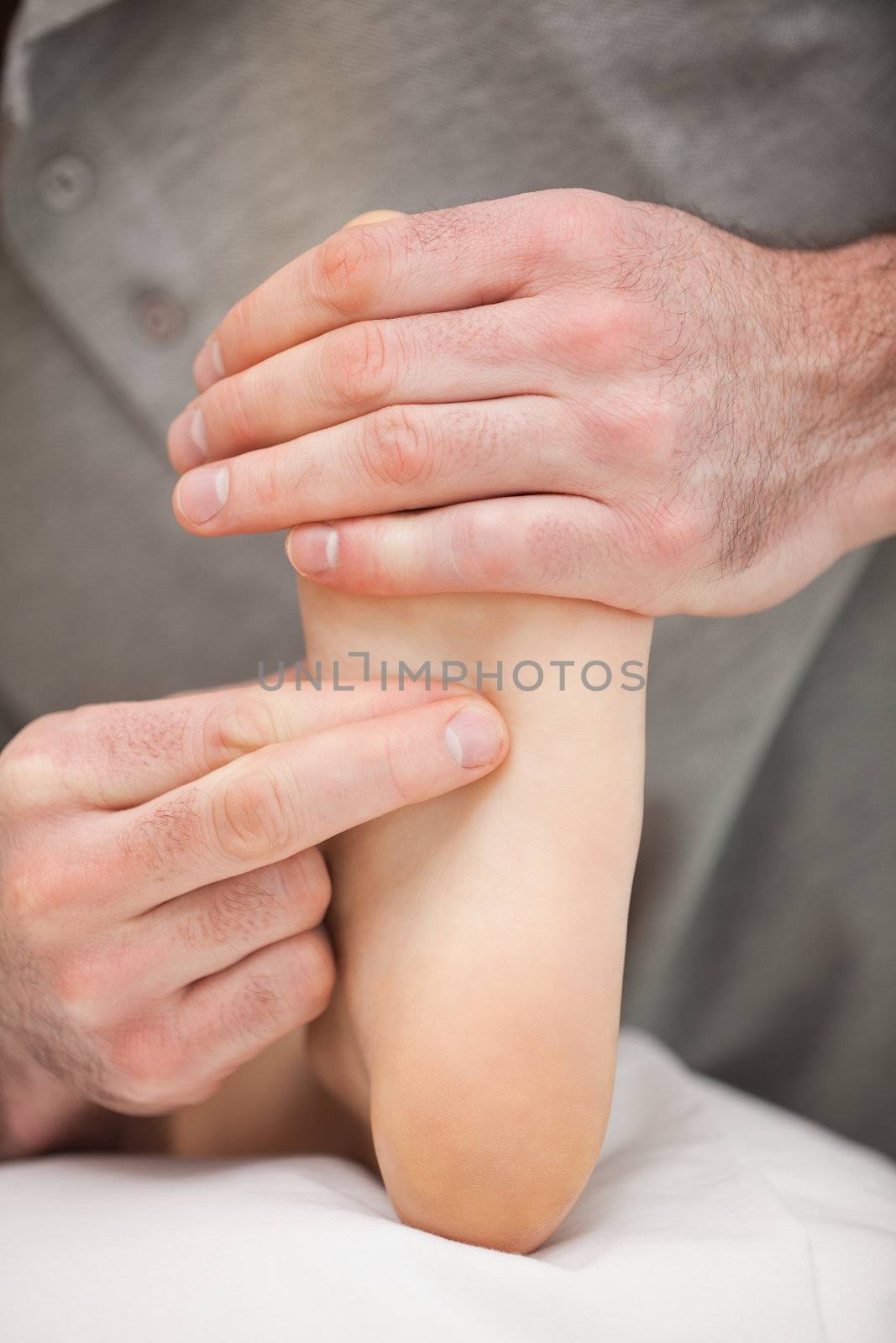 Two fingers pressing the sole of a foot by Wavebreakmedia