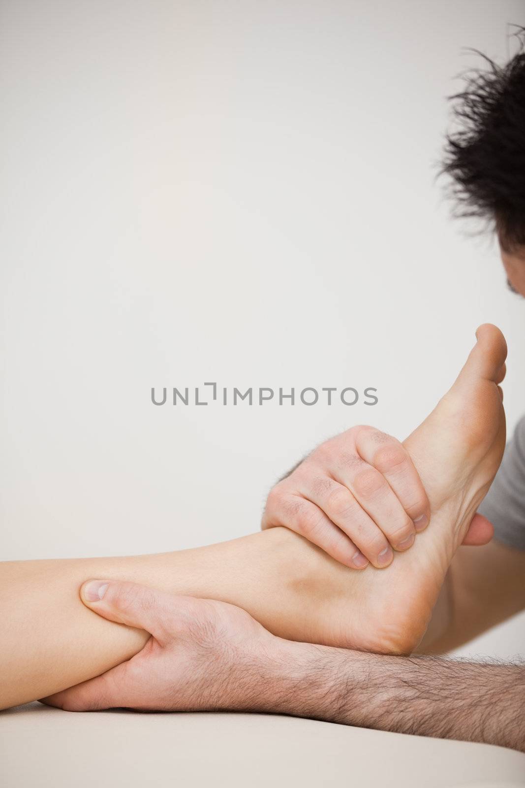 Doctor pressing the side of a foot by Wavebreakmedia
