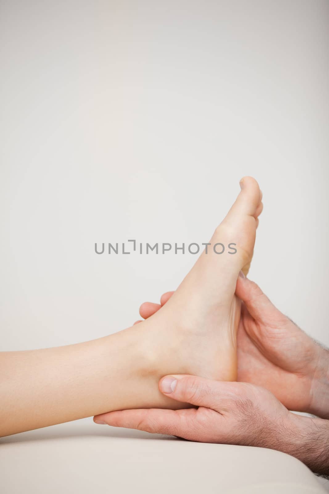 Close-up of a foot being held by a doctor in a medical room