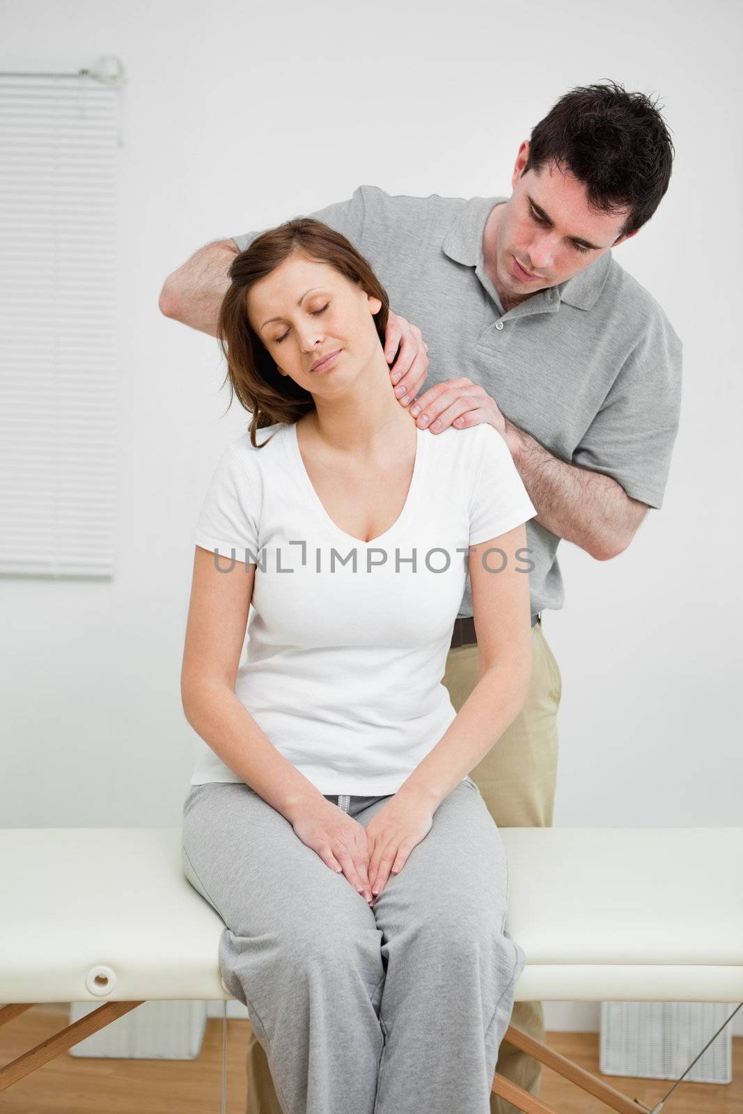Peaceful woman having a painful neck by Wavebreakmedia