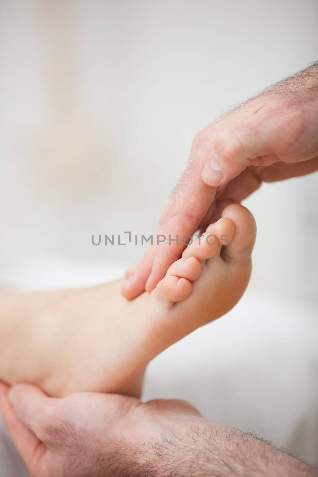 Physiotherapist offering a foot massage in a medical room