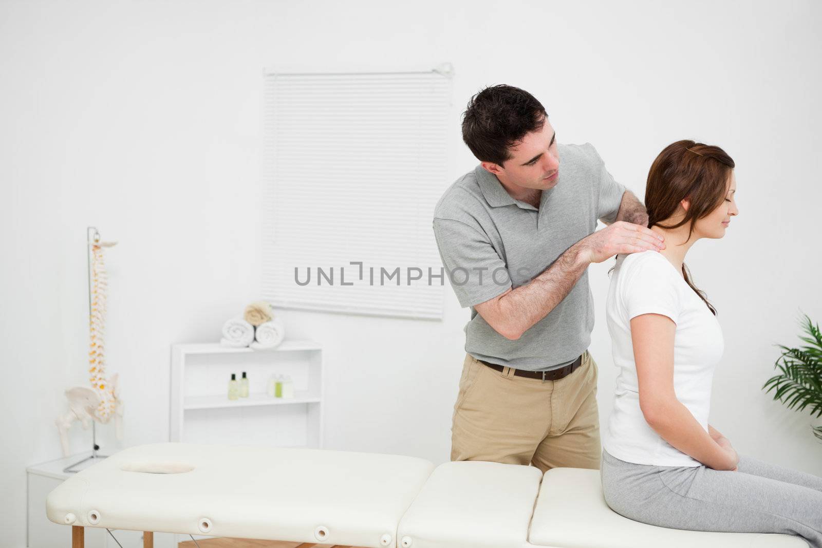 Physiotherapist massaging a brunette woman by Wavebreakmedia