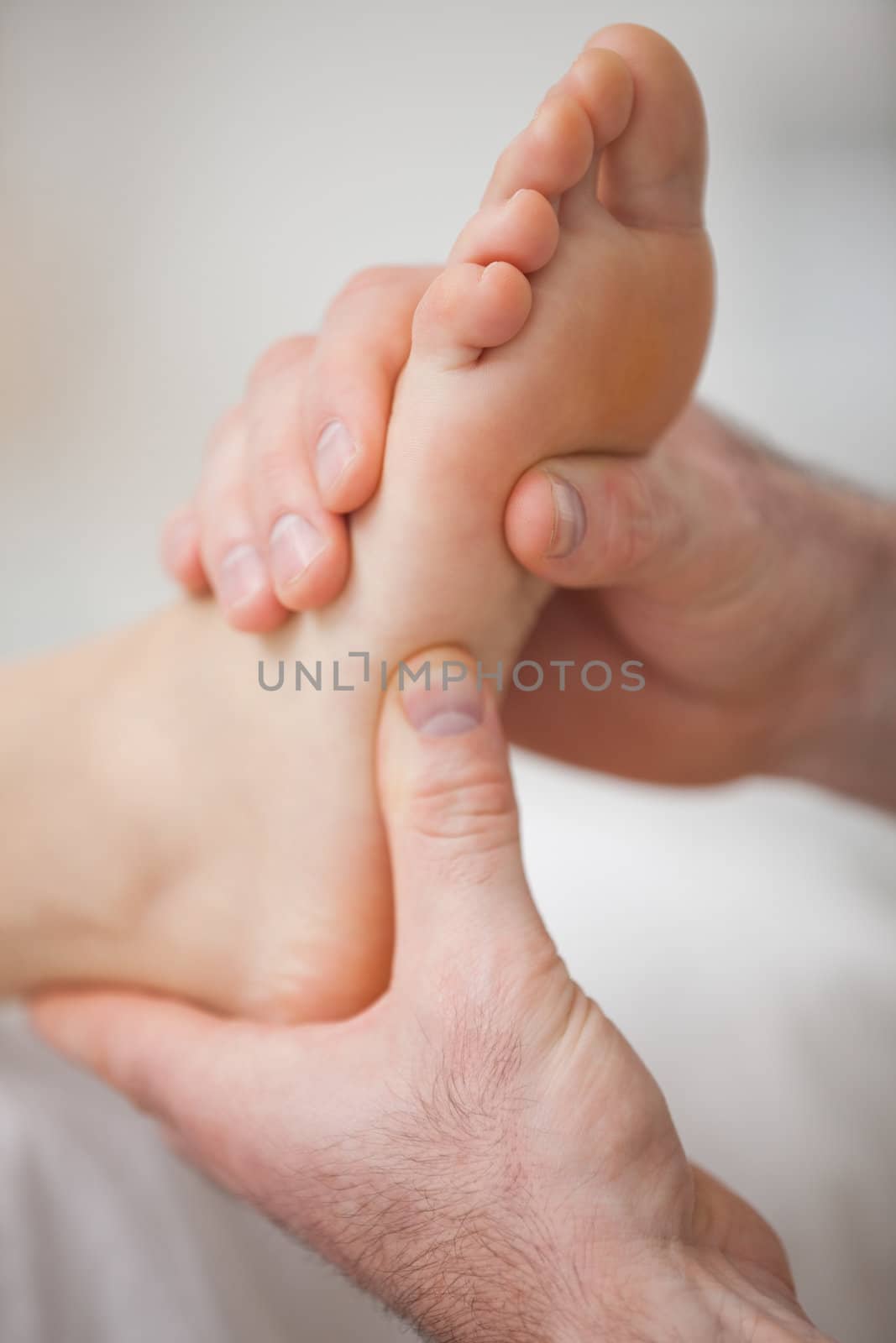 Close-up of two hands massaging a foot by Wavebreakmedia