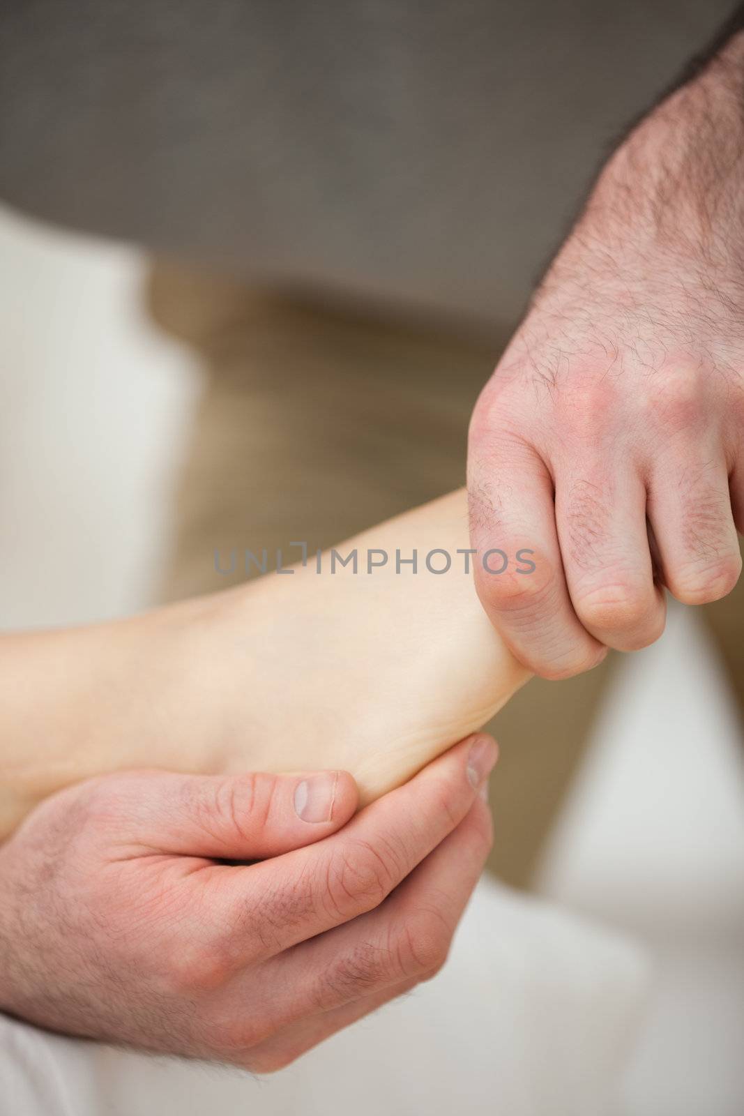 Barefoot being stretched by a doctor indoors